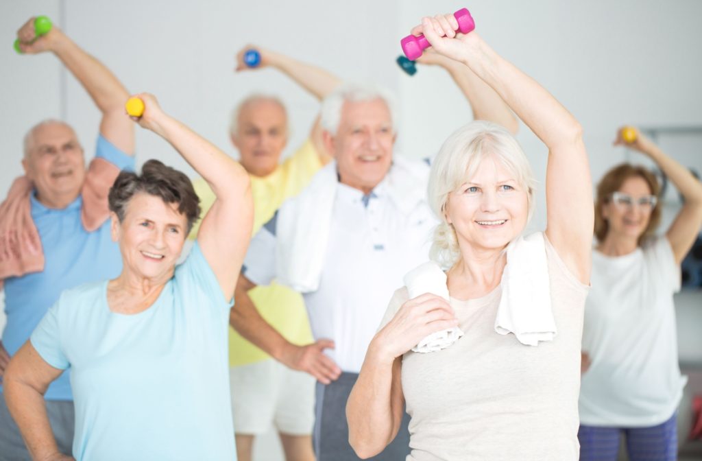 A group of seniors exercising with dumbbells