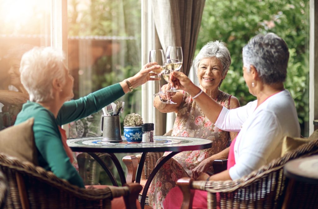 A group of seniors raise their glasses during a friendly brunch.